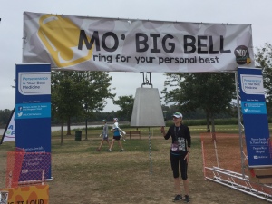 A runner ringing the big bell at the end of the race